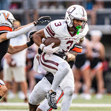 Dowling Catholic wide receiver Jeffrey Roberts (3) attempts to shake off defenders during a high school football game between Valley and Dowling Catholic on Aug. 29, 2025, at Valley Stadium in West Des Moines, Iowa. Valley defeated Dowling Catholic 20-19.