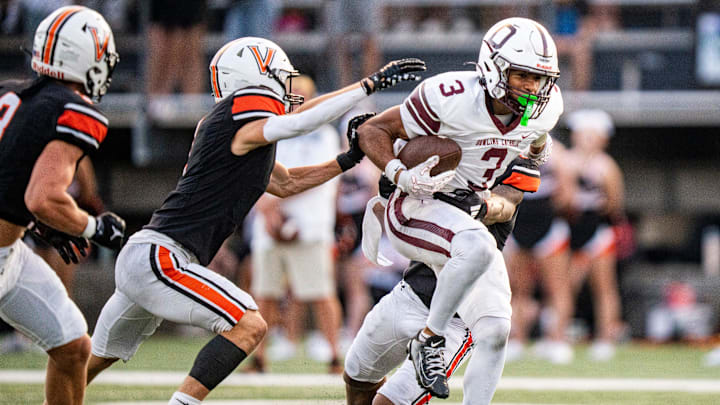 Dowling Catholic wide receiver Jeffrey Roberts (3) attempts to shake off defenders during a high school football game between Valley and Dowling Catholic on Aug. 29, 2025, at Valley Stadium in West Des Moines, Iowa. Valley defeated Dowling Catholic 20-19.
