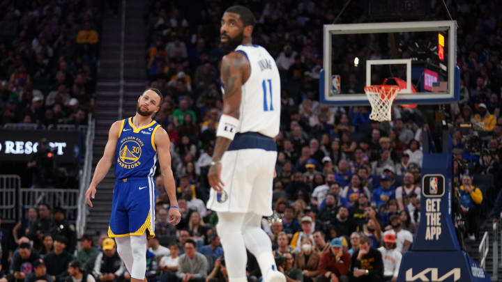 Apr 2, 2024; San Francisco, California, USA; Golden State Warriors guard Stephen Curry (30) and Dallas Mavericks guard Kyrie Irving (11) stand on the court during a break in the action in the third quarter at the Chase Center. 