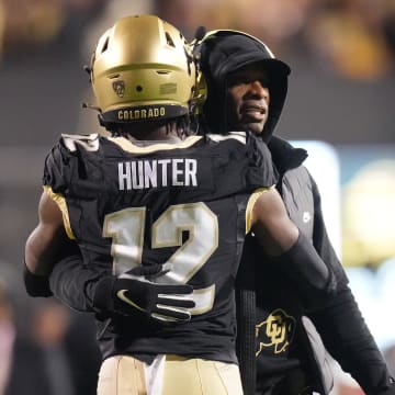Oct 13, 2023; Boulder, Colorado, USA; Colorado Buffaloes wide receiver Travis Hunter (12) is congratulated for his touchdown by head coach Deion Sanders in the first quarter against the Stanford Cardinal at Folsom Field. Mandatory Credit: Ron Chenoy-USA TODAY Sports