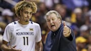 Jan 20, 2020; Morgantown, West Virginia, USA; West Virginia Mountaineers head coach Bob Huggins talks with West Virginia Mountaineers forward Emmitt Matthews Jr. (11) during the second half at WVU Coliseum. Mandatory Credit: Ben Queen-Imagn Images