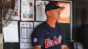 Jun 26, 2022; Omaha, NE, USA; Ole Miss Head Coach Mike Bianco sits in the dugout just before the first inning against the Oklahoma Sooners at Charles Schwab Field. Mandatory Credit: Jaylynn Nash-Imagn Images