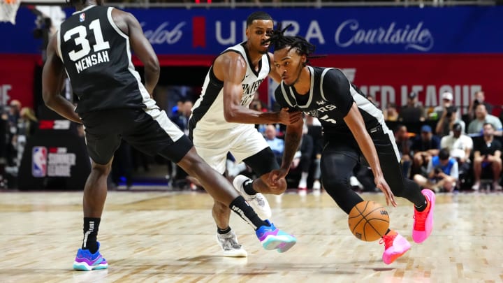 Jul 13, 2024; Las Vegas, NV, USA; San Antonio Spurs guard Stephon Castle (5) dribbles around Portland Trail Blazers forward Kris Murray (10) as San Antonio Spurs forward Nathan Mensah (31) sets a pick during the second quarter at Thomas & Mack Center. Mandatory Credit: Stephen R. Sylvanie-USA TODAY Sports