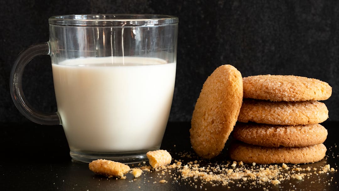 A cup of milk and stack of cookies A cup of milk and stack of cookies