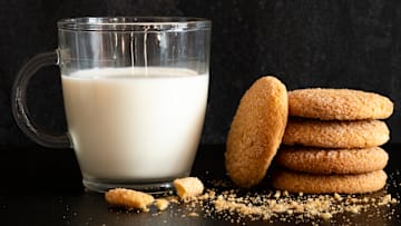 A cup of milk and stack of cookies