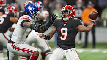 Dec 22, 2024; Atlanta, Georgia, USA; Atlanta Falcons quarterback Michael Penix Jr. (9) passes under pressure from New York Giants linebacker Kayvon Thibodeaux (5) during the first quarter at Mercedes-Benz Stadium. Mandatory Credit: Dale Zanine-Imagn Images