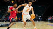 Nov 24, 2025; Las Vegas, NV, USA; Tennessee Volunteers forward Nate Ament (10) dribbles around Rutgers Scarlet Knights guard Jamichael Davis (1) during the first half in a 2025 Players Era Festival group play game at MGM Grand Garden Arena. Mandatory Credit: Stephen R. Sylvanie-Imagn Images
