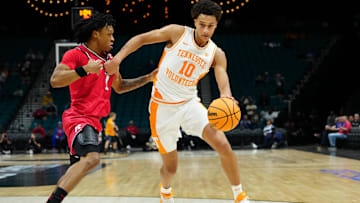 Nov 24, 2025; Las Vegas, NV, USA; Tennessee Volunteers forward Nate Ament (10) dribbles around Rutgers Scarlet Knights guard Jamichael Davis (1) during the first half in a 2025 Players Era Festival group play game at MGM Grand Garden Arena. Mandatory Credit: Stephen R. Sylvanie-Imagn Images