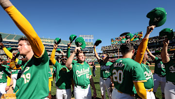 Athletics players celebrating fans after playing their last game in Oakland