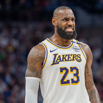 Apr 27, 2025; Minneapolis, Minnesota, USA; Los Angeles Lakers forward LeBron James (23) talks with a referee in the third quarter against the Minnesota Timberwolves during game four of first round for the 2025 NBA Playoffs at Target Center. Mandatory Credit: Matt Blewett-Imagn Images