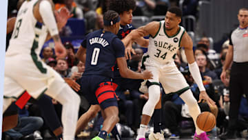 Feb 21, 2025; Washington, District of Columbia, USA; Milwaukee Bucks forward Giannis Antetokounmpo (34) dribbles the ball as Washington Wizards forward Kyshawn George (18) and Wizards guard Bilal Coulibaly (0) defend in the second half at Capital One Arena. Mandatory Credit: Geoff Burke-Imagn Images