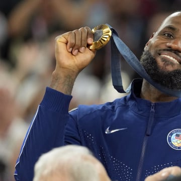 Aug 10, 2024; Paris, France; United States guard LeBron James (6) celebrates with the gold medal after the game against France in the men's basketball gold medal game during the Paris 2024 Olympic Summer Games at Accor Arena. Mandatory Credit: Kyle Terada-USA TODAY Sports