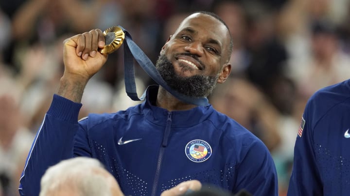 Aug 10, 2024; Paris, France; United States guard LeBron James (6) celebrates with the gold medal after the game against France in the men's basketball gold medal game during the Paris 2024 Olympic Summer Games at Accor Arena. Mandatory Credit: Kyle Terada-USA TODAY Sports