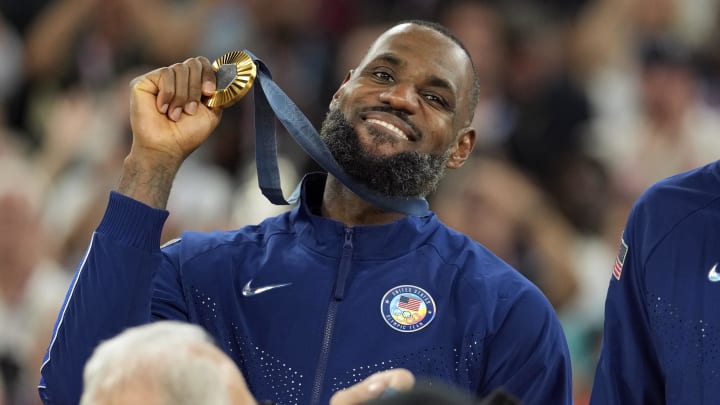 United States guard LeBron James (6) celebrates with the gold medal after the game against France in the men's basketball gold medal game during the Paris 2024 Olympic Summer Games at Accor Arena. Mandatory Credit: