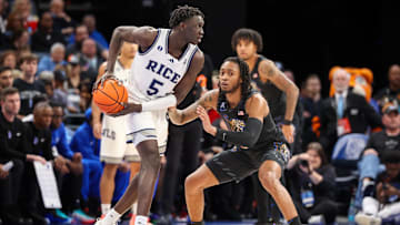 Feb 26, 2025; Memphis, Tennessee, USA; Rice Owls guard Jacob Dar (5) handles the ball against Memphis Tigers guard Colby Rogers (3) during the first half at FedExForum.