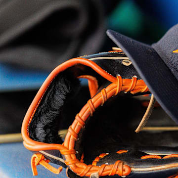 Apr 27, 2025; Kansas City, Missouri, USA; Houston Astros hat and glove in the dugout during the second inning against the Kansas City Royals at Kauffman Stadium. 