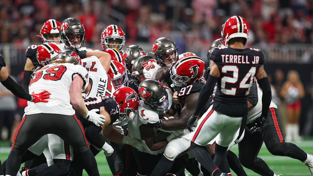 Oct 3, 2024; Atlanta, Georgia, USA; Tampa Bay Buccaneers running back Rachaad White (1) is tackled by Atlanta Falcons defensive end Grady Jarrett (97) in the fourth quarter at Mercedes-Benz Stadium. Mandatory Credit: Brett Davis-Imagn Images