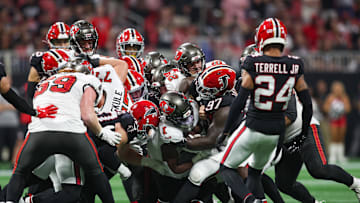 Oct 3, 2024; Atlanta, Georgia, USA; Tampa Bay Buccaneers running back Rachaad White (1) is tackled by Atlanta Falcons defensive end Grady Jarrett (97) in the fourth quarter at Mercedes-Benz Stadium. Mandatory Credit: Brett Davis-Imagn Images
