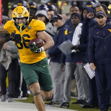 Nov 25, 2023; Waco, Texas, USA; Baylor Bears tight end Jake Roberts (86) runs after the catch past  West Virginia Mountaineers safety Aubrey Burks (2) during the first half at McLane Stadium. Mandatory Credit: Raymond Carlin III-Imagn Images