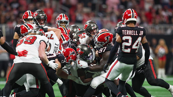 Oct 3, 2024; Atlanta, Georgia, USA; Tampa Bay Buccaneers running back Rachaad White (1) is tackled by Atlanta Falcons defensive end Grady Jarrett (97) in the fourth quarter at Mercedes-Benz Stadium. Mandatory Credit: Brett Davis-Imagn Images
