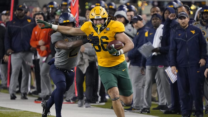 Nov 25, 2023; Waco, Texas, USA; Baylor Bears tight end Jake Roberts (86) runs after the catch past  West Virginia Mountaineers safety Aubrey Burks (2) during the first half at McLane Stadium. Mandatory Credit: Raymond Carlin III-Imagn Images