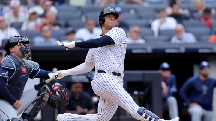 Jul 22, 2024; Bronx, New York, USA; New York Yankees right fielder Juan Soto (22) follows through on a solo home run against the Tampa Bay Rays during the seventh inning at Yankee Stadium.