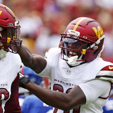 Washington Commanders defensive tackle Javon Kinlaw (99) celebrates with safety Quan Martin (20) 