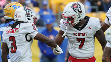 Oct 25, 2025; Pittsburgh, Pennsylvania, USA; North Carolina State Wolfpack tight end Justin Joly (7) celebrates with running back Hollywood Smothers (3) after scoring a touchdown against the Pittsburgh Panthers during the first quarter at Acrisure Stadium. Mandatory Credit: Charles LeClaire-Imagn Images