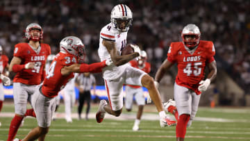 Wide receiver Tetairoa McMillan #4 of the Arizona Wildcats runs past safety Noa Pola-Gates #34 of the New Mexico Lobos during the second half at Arizona Stadium on August 31, 2024 in Tucson, Arizona. McMillan has set the program single game receiving record.