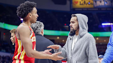 Oct 17, 2024; Oklahoma City, Oklahoma, USA; Atlanta Hawks guard Kobe Bufkin (4) and guard Trae Young (11)  high five during a time out against the Oklahoma City Thunder during the second half at Paycom Center. Mandatory Credit: Alonzo Adams-Imagn Images