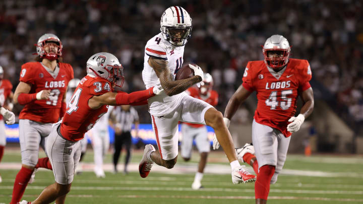 Wide receiver Tetairoa McMillan #4 of the Arizona Wildcats runs past safety Noa Pola-Gates #34 of the New Mexico Lobos during the second half at Arizona Stadium on August 31, 2024 in Tucson, Arizona. McMillan has set the program single game receiving record.