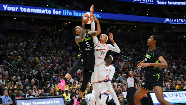 A photo of Gabby Williams attempting a shot against DeWanna Bonner
