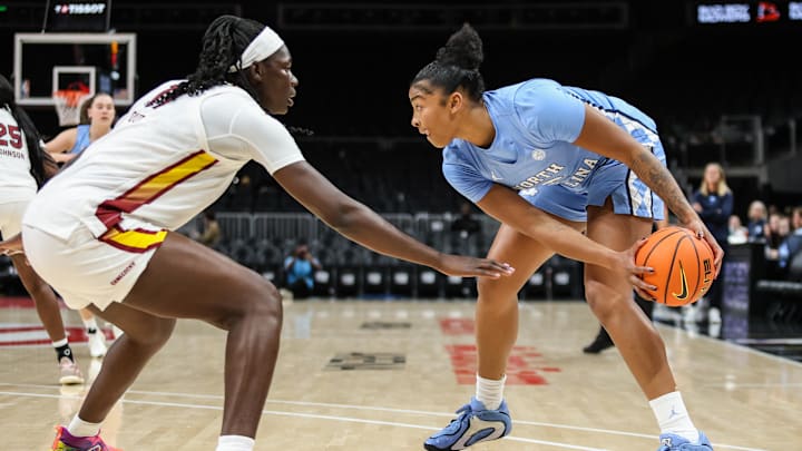 Oct 30, 2025; Atlanta, GA, USA; North Carolina Tar Heels forward Nyla Harris (2) protects the ball against South Carolina Gamecocks center Madina Okot (11) during the first quarter at State Farm Arena. Mandatory Credit: Jordan Godfree-Imagn Images