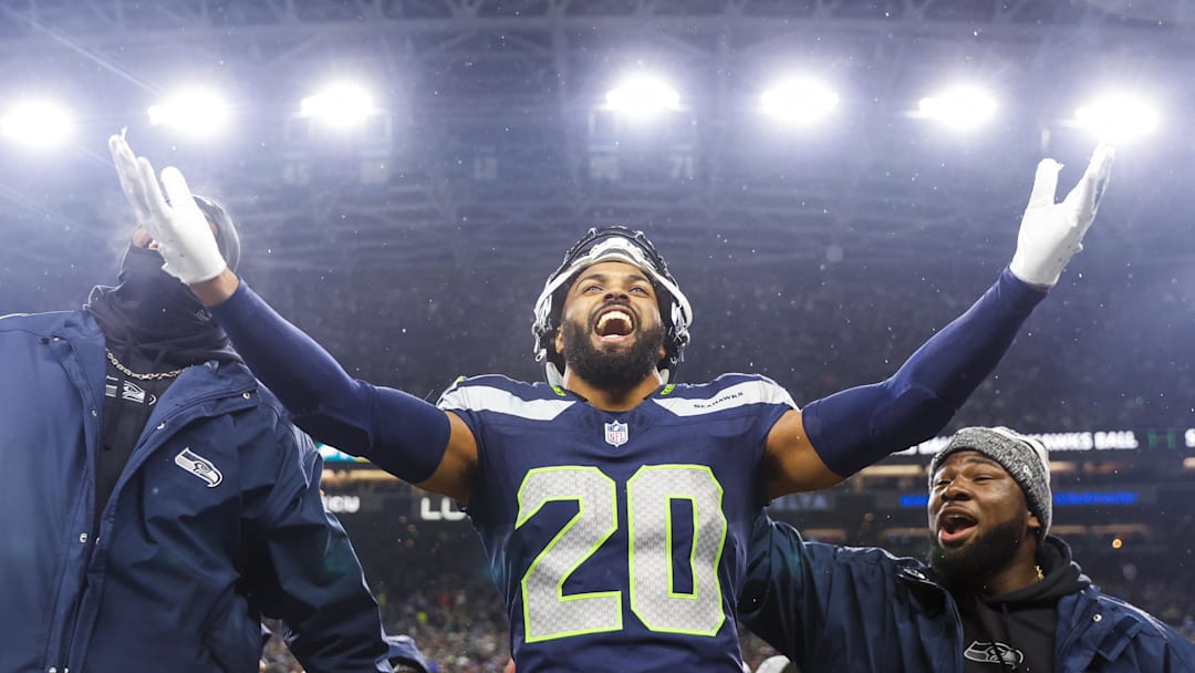 Dec 18, 2023; Seattle, Washington, USA; Seattle Seahawks safety Julian Love (20) celebrates on the bench after his second interception of the fourth quarter against the Philadelphia Eagles at Lumen Field. Mandatory Credit: Joe Nicholson-Imagn Images