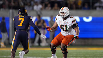 Oct 5, 2024; Berkeley, California, USA; Miami Hurricanes offensive lineman Francis Mauigoa (61) blocks against California Golden Bears linebacker David Reese (7) during the first quarter at California Memorial Stadium. Mandatory Credit: Darren Yamashita-Imagn Images