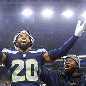 Dec 18, 2023; Seattle, Washington, USA; Seattle Seahawks safety Julian Love (20) celebrates on the bench after his second interception of the fourth quarter against the Philadelphia Eagles at Lumen Field. Mandatory Credit: Joe Nicholson-Imagn Images