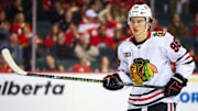 Nov 7, 2025; Calgary, Alberta, CAN; Chicago Blackhawks center Connor Bedard (98) during the face off against the Calgary Flames during the first period at Scotiabank Saddledome. Mandatory Credit: Sergei Belski-Imagn Images