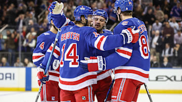 Oct 23, 2025; New York, New York, USA;  New York Rangers right wing Taylor Raddysh (14) celebrates with his teammates after scoring a goal in the first period against the San Jose Sharks at Madison Square Garden. Mandatory Credit: Wendell Cruz-Imagn Images