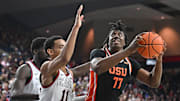 Jan 28, 2025; Spokane, Washington, USA; Oregon State Beavers forward Maxim Logue (77) shoots the ball against Gonzaga Bulldogs guard Nolan Hickman (11) in the second half at McCarthey Athletic Center. Mandatory Credit: James Snook-Imagn Images