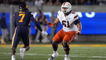 Oct 5, 2024; Berkeley, California, USA; Miami Hurricanes offensive lineman Francis Mauigoa (61) blocks against California Golden Bears linebacker David Reese (7) during the first quarter at California Memorial Stadium. Mandatory Credit: Darren Yamashita-Imagn Images