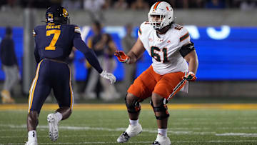 Oct 5, 2024; Berkeley, California, USA; Miami Hurricanes offensive lineman Francis Mauigoa (61) blocks against California Golden Bears linebacker David Reese (7) during the first quarter at California Memorial Stadium.