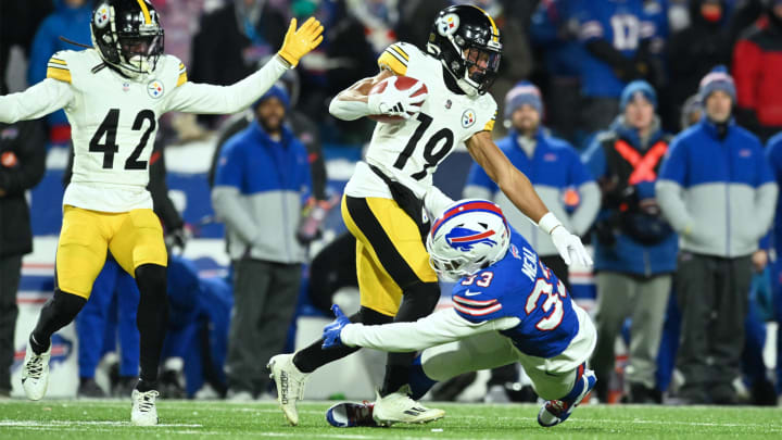 Jan 15, 2024; Orchard Park, New York, USA; Pittsburgh Steelers wide receiver Calvin Austin III (19) is tackled by Buffalo Bills cornerback Siran Neal (33) in the second half in a 2024 AFC wild card game at Highmark Stadium.