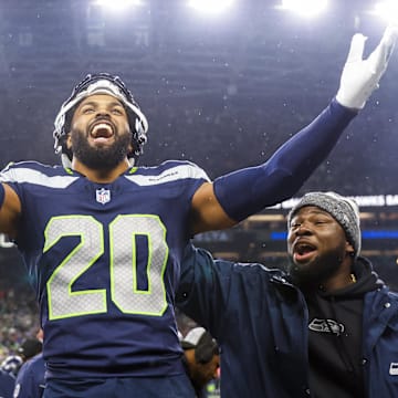 Dec 18, 2023; Seattle, Washington, USA; Seattle Seahawks safety Julian Love (20) celebrates on the bench after his second interception of the fourth quarter against the Philadelphia Eagles at Lumen Field. Mandatory Credit: Joe Nicholson-Imagn Images