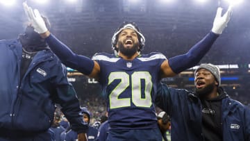 Dec 18, 2023; Seattle, Washington, USA; Seattle Seahawks safety Julian Love (20) celebrates on the bench after his second interception of the fourth quarter against the Philadelphia Eagles at Lumen Field. Mandatory Credit: Joe Nicholson-USA TODAY Sports