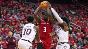 Dec 23, 2023; Newark, NY, USA; Rutgers Scarlet Knights forward Mawot Mag (3) drives to the basket as Mississippi State Bulldogs guard Dashawn Davis (10) and forward Cameron Matthews (4) during the first half at Prudential Center. Mandatory Credit: Vincent Carchietta-USA TODAY Sports