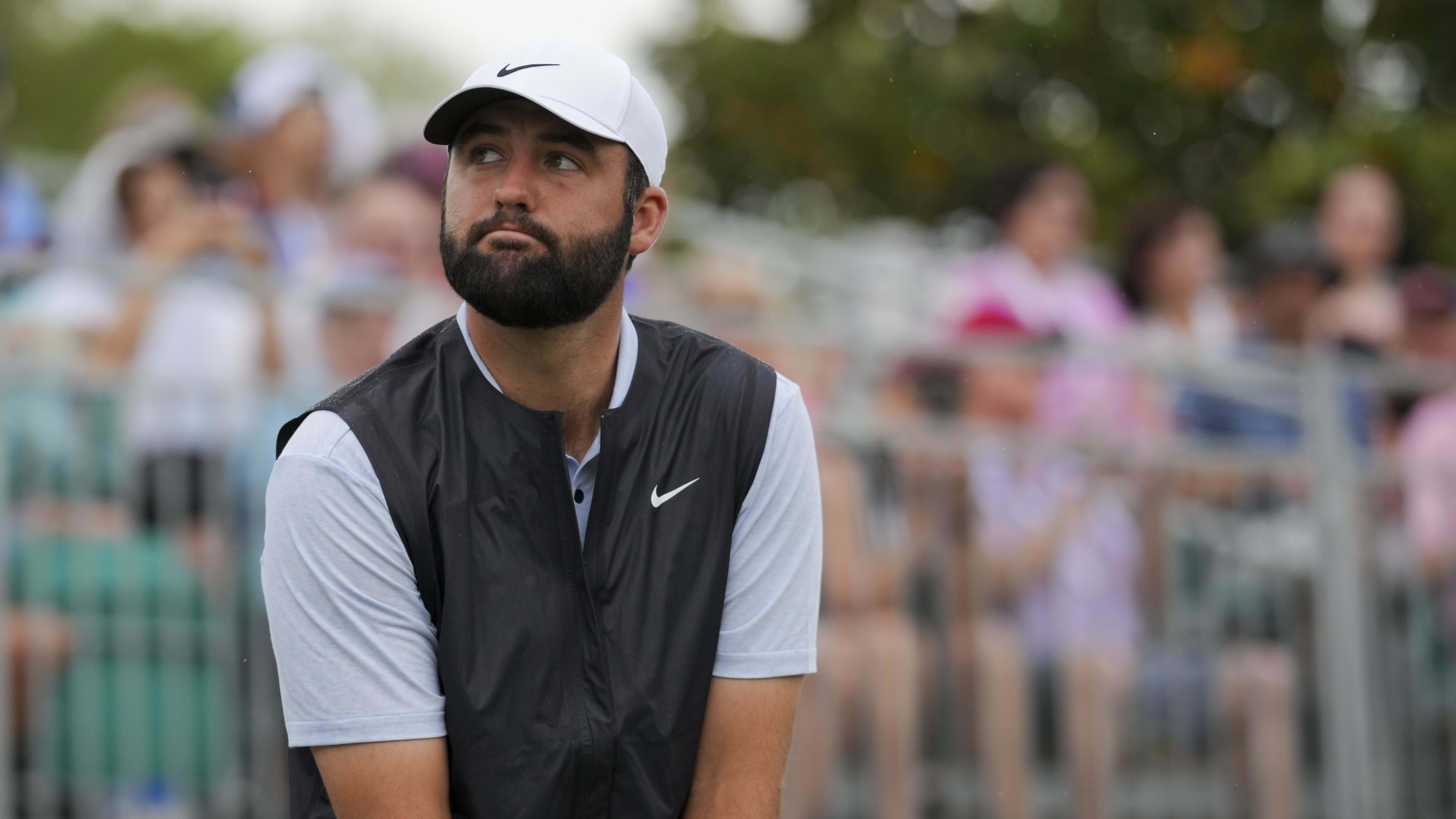 Scottie Scheffler acknowledges fans as he prepares to hit at the 2024 RBC Heritage.