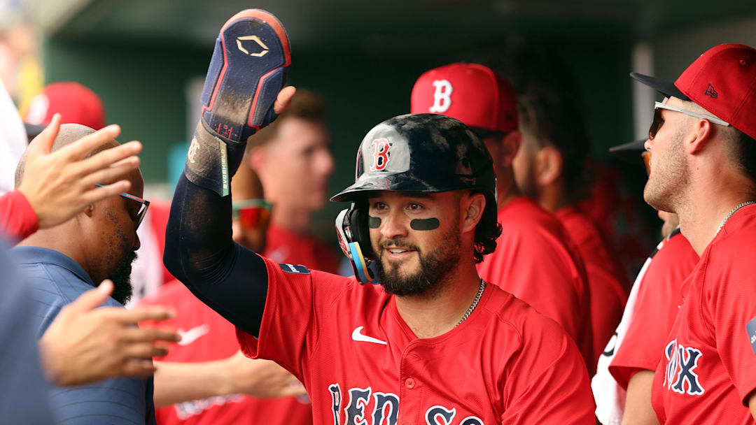 Mar 16, 2024; Sarasota, Florida, USA;  Boston Red Sox infielder Eddy Alvarez (67) is congratulated after he scored a run during the second inning against the Baltimore Orioles at Ed Smith Stadium. Mandatory Credit: Kim Klement Neitzel-Imagn Images