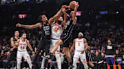 Jan 21, 2025; Brooklyn, New York, USA;  Brooklyn Nets center Nic Claxton (33) and guard Tyrese Martin (13) fight with New York Knicks center Karl-Anthony Towns (32) for a rebound in the second quarter at Barclays Center. Mandatory Credit: Wendell Cruz-Imagn Images