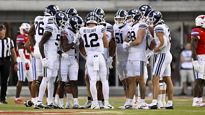 Sep 6, 2024; Dallas, Texas, USA; Brigham Young Cougars quarterback Jake Retzlaff (12) huddles with his team during the game between the Southern Methodist Mustangs and the Brigham Young Cougars at Gerald J. Ford Stadium. 