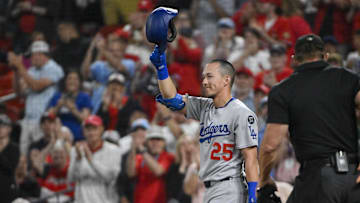 Jun 6, 2025; St. Louis, Missouri, USA;  Los Angeles Dodgers second baseman Tommy Edman (25) salutes the fans as he receives a standing ovation in his return to St. Louis before his first at bat against the St. Louis Cardinals at Busch Stadium. Mandatory Credit: Jeff Curry-Imagn Images